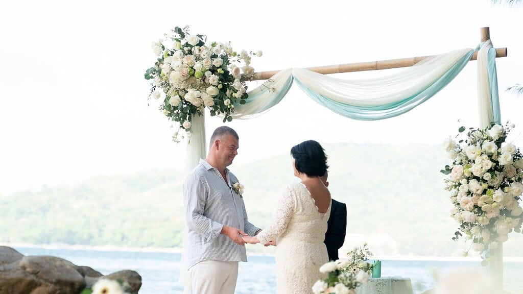 A private wedding vow renewal on a Phuket beach at sunset.